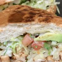 Torta Sandwich · Mexican sub sandwich with meat, lettuce, tomatoes, melted cheese, avocado, cilantro, and oni...