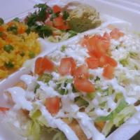 Flautas De Pollo Plate · 3 crispy shredded chicken corn tortilla tacos. Served with rice and beans, lettuce, pico de ...