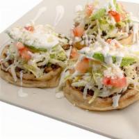 Sopes Plate · 3 deep fried handmade tortillas topped with refried beans and meat. Topped with lettuce, tom...