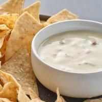 Chips & Queso · 16 oz of melted queso blanco with a blend of hatch chiles, poblano and jalapeno peppers resu...