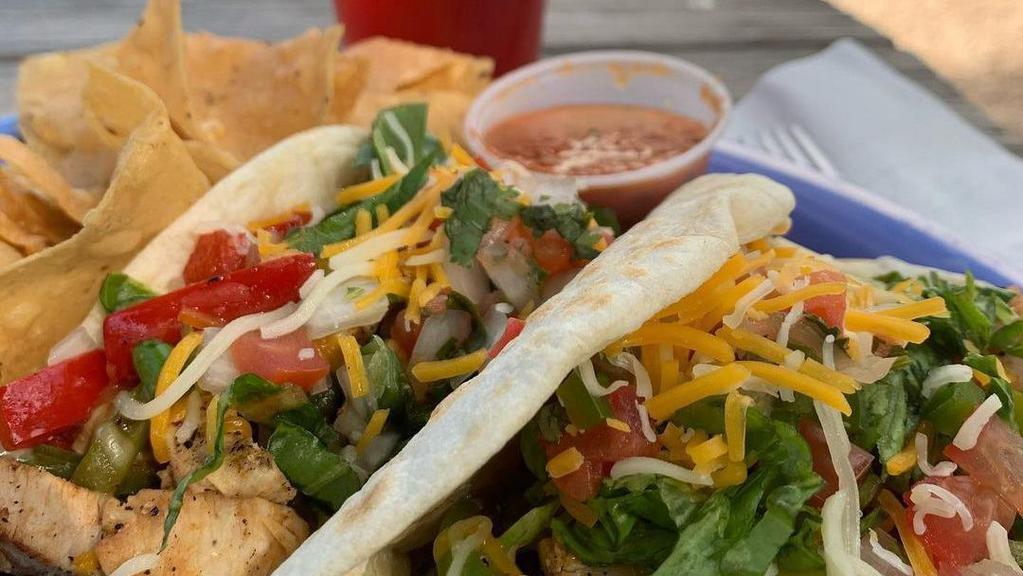 Chicken Tacos · Chicken breast with peppers and onions. Topped with lettuce, pico de gallo, and Cheddar. Two tacos served with chips and salsa or a cucumber salad.