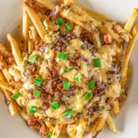 Loaded Fries · Queso, black beans, bacon, and green onion, served with sour cream.