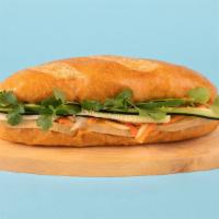 Tofu Banh Mi · Tofu with cucumber, jalapeno, cilantro, pickled carrots and sriracha mayo on a french roll.