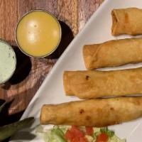 Chicken Flautas · Crispy fried flautas stuffed with shredded chicken, cheese and spices. Served with chile con...