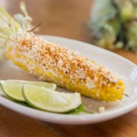 Fire Roasted Street Corn · Fresh corn on the cob, fire roasted and basted with butter, mayonnaise, cotija cheese, sprin...
