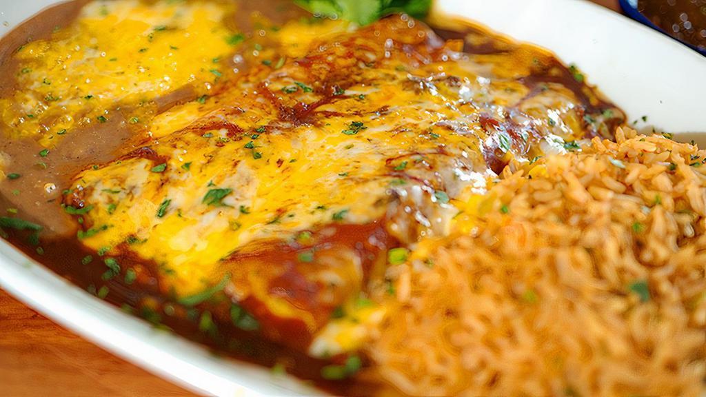 Cheese Enchiladas · Three enchiladas filled with a blend of cheese and topped with chili con carne. Served with Mexican rice and choice of beans.