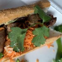 Grilled Pork Banh Mi · Served on toasted baguette with pickled veggies, cucumbers, sliced jalapeños, cilantro, and ...