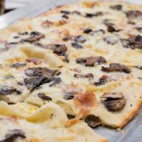 Black Truffle Roman Style Pizza · Very thin crust. House-made mozzarella, speck Italian ham, mushrooms, truffle oil, and black...