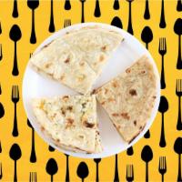 Butter Naan · Indian white flour flatbread baked to perfection in a traditional Indian clay oven and glaze...