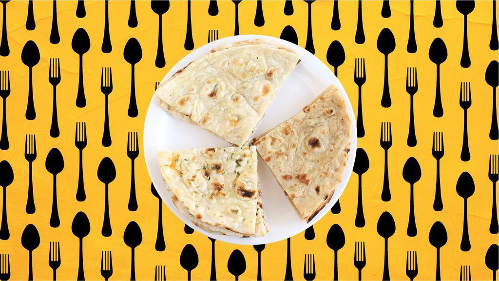 Butter Naan · Indian white flour flatbread baked to perfection in a traditional Indian clay oven and glazed with butter.