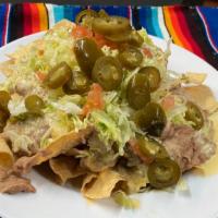 Lunch Box Nachos · White corn tostadas topped with our Chile con Queso sauce, refried beans, tomato, sour cream...