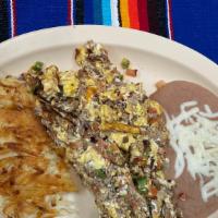 Machaca · Three eggs scrambled with jalapenos onions meat and diced tomatoes served with refried beans...