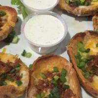 Potato Skins · Crispy bacon and chives smothered in melted cheddar cheese and served with ranch or sour cre...