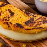 Cachapa · Corn pancake stuffed with hand stretched cheese and butter.