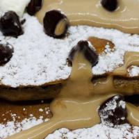 Belgian Chocolate Pancakes · Fresh Belgian Chocolate pancakes with toasted coconut and topped with melted Belgian chocola...