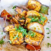 Paneer Tikka · Marinated paneer chunks cooked in tandoor. Served with mint sauce.
