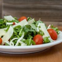 Italian-Style Treciolina Salad · Organic baby arugula, spinach, shaved parmesan, cherry tomato, and mozzarella cheese in a ba...
