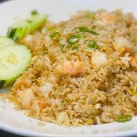 Shrimp Fried Rice · Stir fry Shrimps,Rice, Eggs, Chopped onions top with Green onions and Slices fresh Cucumber.