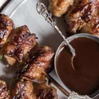 Texas Quail Bites · Four skewers of grilled marinated quail wrapped in bacon and a thick slice of jalapeno. Serv...