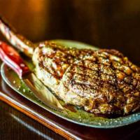 Tomahawk Ribeye · Serious steak for a serious steak lover. Impressive 38 ounces with a 14