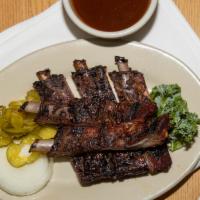 Louis Style Ribs · St. Louis Style Ribs barbecued with a Texas Twist.  Served with Sauce,  Pickles, Onions,  Ba...