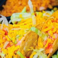 Los Crispy Tacos · Three picadillo beef crispy tacos, topped with lettuce, tomatoes and shredded cheese. Served...