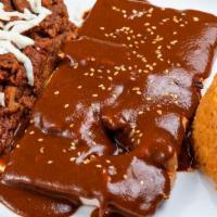 Chicken Mole · Tender chicken breast covered with mole sauce, served with rice, mom's refried beans and tor...