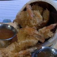 Coconut Shrimp · Jumbo shrimp coated in a delicious coconut batter, fried flaky and golden and served with ou...