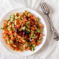 Tomato Cucumber Salad · Chopped cucumbers, tomatoes, onions, and fresh herbs in lime juice with olive oil.