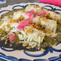 Enchiladas Suizas · Shredded chicken enchiladas, covered with green tomatillo sauce, topped with Oaxaca cheese, ...