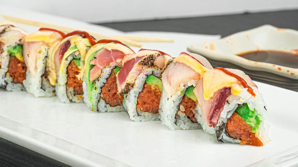 Sexy Lady Roll · Spicy tuna, avocado inside, top with black-pepper tuna and yellow tail with spicy sauce on top.