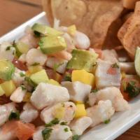 Chips & Tropical Ceviche · Fish and shrimp marinated in key lime / mango / pineapple / tomatoes / onions / cilantro / a...