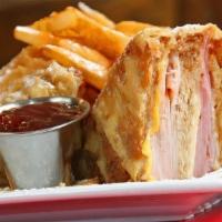 Monte Cristo · Whole wheat bread layered with sliced turkey, ham, Swiss and American cheeses. Deep fried an...