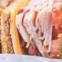 The Club Sandwich · Smoked turkey, ham, applewood bacon, swiss and American cheeses, lettuce, tomato, on toasted...
