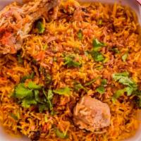 Chicken Biryani · Long-grained rice flavored with exotic spices, layered with chicken and a thick gravy.