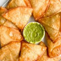 Potato Samosas (2) · A delicious crispy shell stuffed with potato and exotic spices with a green sauce made with ...