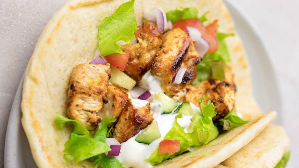 Chicken Gyro · Greek chicken gyros with tzatziki sauce wrapped in a toasted pita bread with a delicious salad.