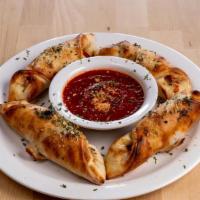 4 Pizza Rolls · Filled with pepperoni and mozzarella. Served with sauce.