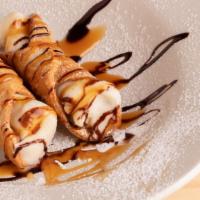 Cannoli · Sweet ricotta cream and chocolate filled pastry with powdered sugar.