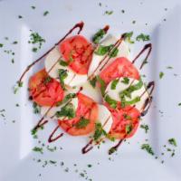 Mozzarella Caprese · Sliced fresh mozzarella, tomatoes, fresh basil, extra virgin olive oil drizzle