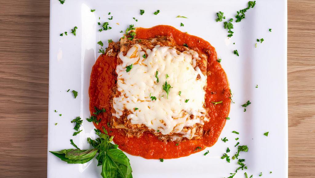 Lasagna Bolognese · Traditional Lasagna with Bolognese ground beef tomato sauce, ricotta, parmesan cheese