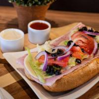 Ham And Cheese Sub · Delicious ham and provolone cheese with roasted peppers, romaine lettuce, red onions, tomato...