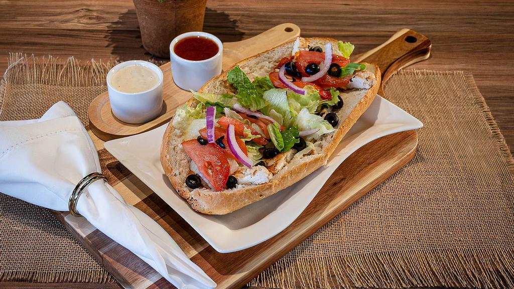 Grilled Chicken Sub · Seasoned grill chicken with roasted peppers, romaine lettuce, red onions, tomatoes, black olives and provolone cheese along with red tomato vinaigrette house dressing. Choice of dressings available.