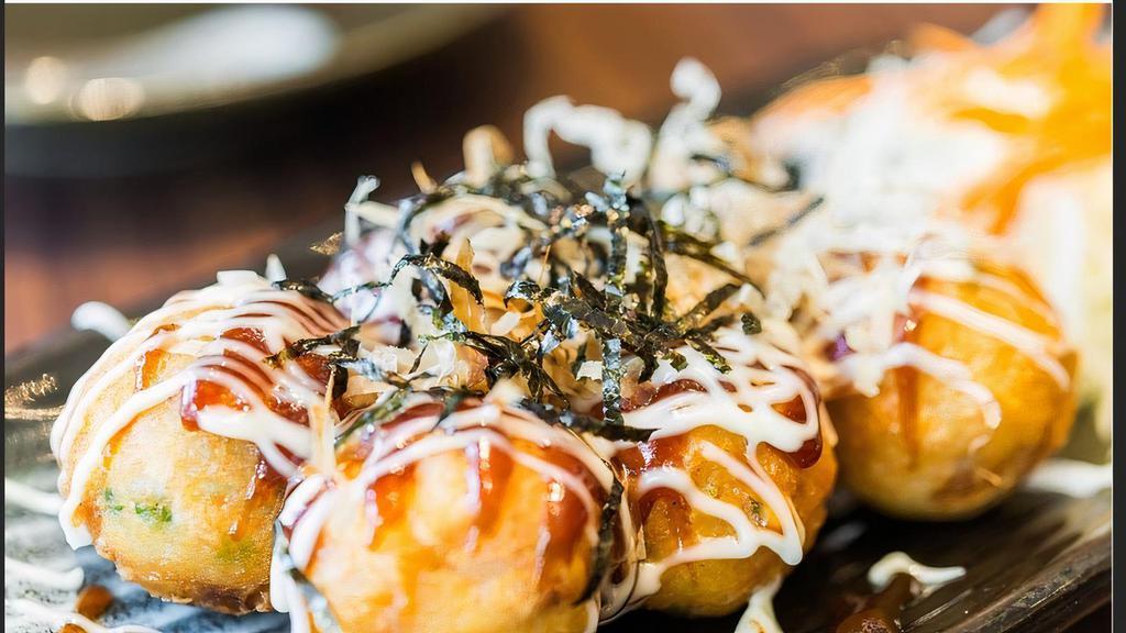 Takoyaki · 5 pieces. Baked octopus ball with mayo and eel sauce, dried fish flakes on top.