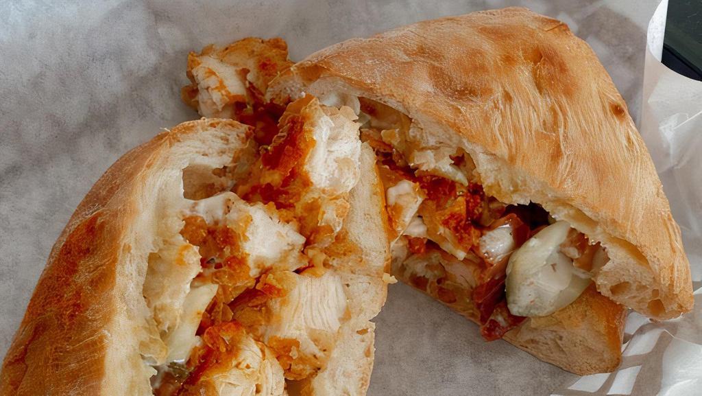 Hot Wang · Crispy Chicken Tender with Buffalo Sauce, Crispy Bacon, Pickled Celery, Blue Cheese Ranch Dressing, on Ciabatta