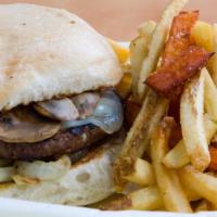 Travis Heights Burger · A burger topped with swiss cheese, grilled onion, and grilled mushrooms on a toasted sourdou...