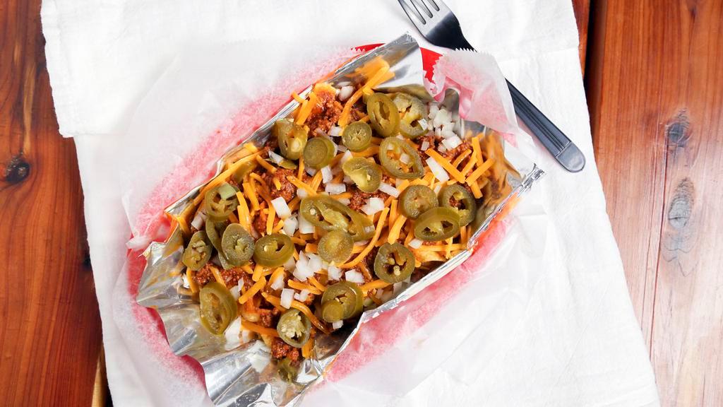 Frito Pie · Frito’s corn chips topped with chili, cheddar cheese, onions, and jalapeños. No fries.