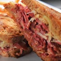 Classic Reuben · Traditional Reuben piled high with corned beef, peppered sauerkraut, melted Swiss cheese and...