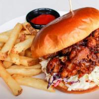The Smokin' Outlaw · Smoked beer BBQ pork topped with Sriracha mayo and Southern Slaw on a toasted brioche bun.