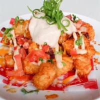 Loaded Tater Tots · Cheddar & jack cheeses, bacon, diced tomato, green onions, chipotle sour cream.